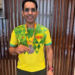 Another shot of a happy runner with his medal. The smile of accomplishment is what we train for.