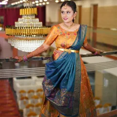 A beautiful shot of Yoshitha at her event, with a grand chandelier in the background. Her makeup is bright and fresh to match the festive atmosphere.