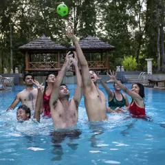 A perfect way to beat the heat! A group enjoys a game of water polo in our swimming pool, a great activity for team bonding and friendly competition.