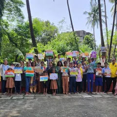 A group photo with all the young artists and organizers at the Lions Club of Juhu art competition. It was a beautiful afternoon celebrating art and community, surrounded by palm trees and happy faces.