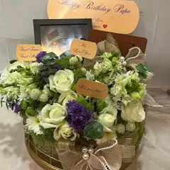 Another view of the heartfelt birthday hamper, showing the lushness of the floral arrangement and the thoughtful personalized tags.