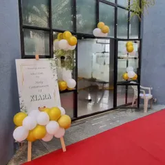 The entrance to the Holy Communion event, with a personalized welcome sign and a red carpet.