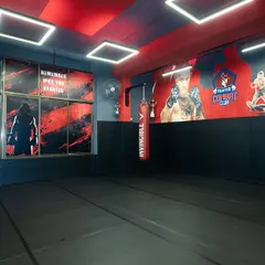 A wide view of our training floor, with the cage in the background and murals of MMA legends on the wall to inspire you. This is where you will grind.