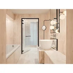 This bathroom design uses floor-to-ceiling travertine marble to create a seamless, monolithic feel. The clean lines, statement basin, and modern lighting fixture reflect our approach to creating calm, uncluttered spaces.