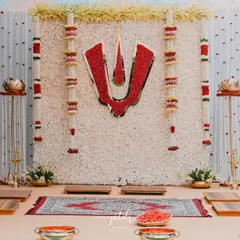 A close-up of the Nalugu stage, with the stunning chrysanthemum backdrop and red Balaji Nama. The traditional seating and props complete the sacred setting.