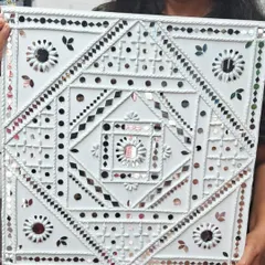 A close up of a finished Lippan art piece, highlighting the geometric patterns and shimmering mirror work. Our students learn to create these intricate designs from scratch.