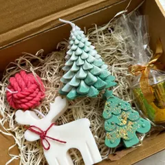 A peek inside one of my Christmas gift boxes. This one includes a variety of my festive candle shapes, including trees and a reindeer, nestled in kraft paper.