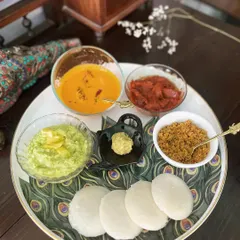 A perfect breakfast platter featuring soft idlis served with a variety of my chutneys and podis. You can see how the deep colour of the Chammanthi Podi offers a delicious contrast to the other accompaniments, proving it has star billing in any South Indian meal.