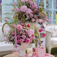 A close-up of the details from a 'Mayfair Luncheon'. Pastel florals, lavender candles, and scalloped trays came together to create an atmosphere of easy elegance and thoughtful touches.