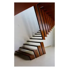 The staircase in our Boxed In House project, fabricated from teakwood recycled from the original demolished structure. This element is a centerpiece of the design, demonstrating our commitment to material sustainability and bespoke craftsmanship in residential architecture.
