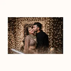 A romantic kiss against a backdrop of sparkling lights. This beautifully lit portrait from a reception is the epitome of romance and celebration.