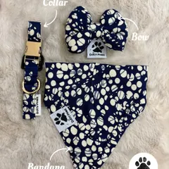 A classic navy and white printed accessory set. This flat lay shows the adjustable collar with a rose gold buckle, a matching bow, and a stylish bandana.