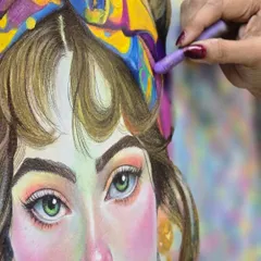 A stunning close-up of an oil pastel portrait, showcasing the incredible detail achieved in the eyes and the smooth blending of colors on the skin and hair. This is what our advanced pastel classes can teach you.