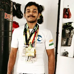 Wearing some of the medals I've earned over the years in kickboxing and BJJ competitions. Each one tells a story of hard work and dedication.