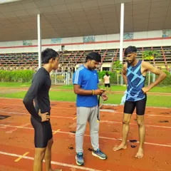 Reviewing performance data on my stopwatch with my athletes right after a drill. Immediate feedback is essential for learning and improvement.