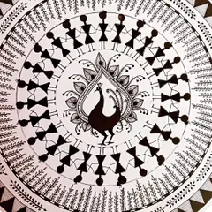 A close-up of my Warli art piece, a traditional folk art style from Maharashtra. I love creating the simple, geometric shapes that depict a story, here showing people dancing around a central peacock motif.