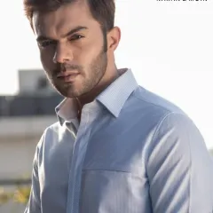 A light blue shirt with a subtle texture. This is a versatile staple for any wardrobe, tailored for a crisp, refined look.