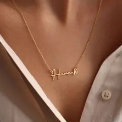 The 'Hannah' nameplate necklace in a classic font, demonstrating a clean and elegant take on the personalized script style. It's a subtle statement of identity.