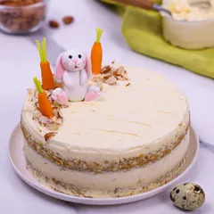 A full view of the Easter carrot cake, showing its rustic-chic semi-naked frosting.