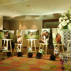 A beautiful way to honor the couple's journey. I created this gallery of their personal photos displayed on easels, allowing guests to share in their story. It's a simple touch that adds immense personal value.