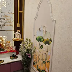 A close-up of the hand-painted pichwai-style art panel, which adds a traditional and artistic touch to the modern mandir design.