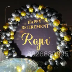 A detailed shot of the balloon arch for the retirement party, showcasing the mix of black, chrome gold, and silver balloons for a professional look.