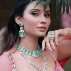 A fresh, blushy, and natural look perfect for any special day. The soft pink tones in the makeup beautifully complement the emerald and diamond jewelry.