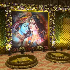 The centerpiece of a traditional Haldi ceremony. We created this stunning backdrop with a Radha Krishna painting, surrounded by a thick floral border and traditional brass urlis for the ceremony.