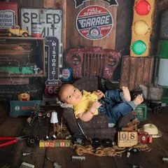 Wide awake and ready for work! Even when babies are awake, I can capture wonderful moments within my themed setups, like this little mechanic looking right at the camera.
