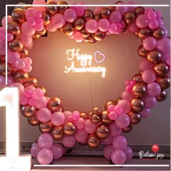 Celebrating one year of togetherness with this beautiful heart-shaped balloon frame in shades of pink and rose gold. The soft glow from the neon sign and the "1" marquee light adds a magical touch to the first-anniversary surprise.