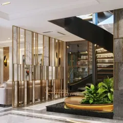 A view of the atrium's mirrored partition, which cleverly separates the space while reflecting light and adding a sense of glamour. The base of the spiral staircase features an integrated planter.