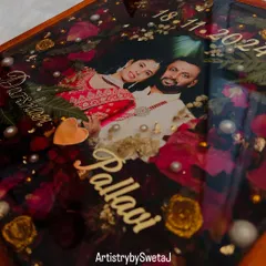 A closer look at the details that make a memory last. Here, you can see the preserved rose petals, delicate leaves, and pearl accents that surround the couple's photo in this custom varmala frame.