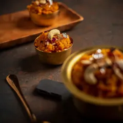 A beautiful close-up of our Gajar ka Halwa, served in a traditional brass bowl. This sweet surprise is a favourite for a reason.