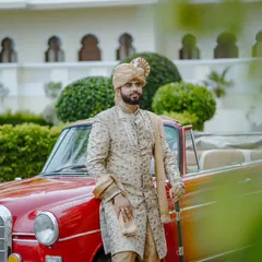 A stately pose against a vintage car and lush palace gardens. This image captures the groom in his element, embodying the grace and power of a king in his kingdom.