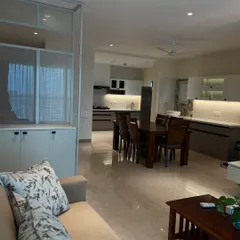 An open-plan living and dining area designed for seamless flow. The neutral color palette and clean lines create a spacious and calming environment.