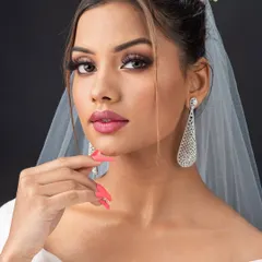 Creating the perfect Christian bridal look is about soft elegance. Here, my student has beautifully executed a minimal yet glowing makeup look, paired with a classic updo and veil.