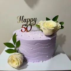 A lovely lavender cake for a 50th birthday. This one-kg Dutch Truffle cake is decorated with fresh white roses and a golden "Happy 50th" topper.