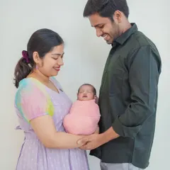 Capturing the candid, loving glances between parents and their new baby. These unposed moments are often the most cherished from a family newborn session.