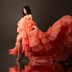 This shot is pure drama and elegance. The vibrant orange ruffled gown creates incredible movement, and the reflection adds a unique artistic touch to this maternity portrait. It’s a perfect example of a bold, fashion-forward pregnancy photoshoot.