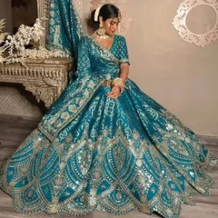 A perfect example of a regal look for a Sangeet or reception. This teal blue and gold lehenga features intricate gota patti and mirror work, ensuring you look absolutely radiant for any grand celebration.
