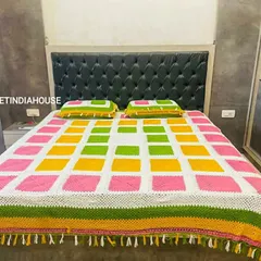 A full view of the vibrant bedspread, showcasing the detailed tassel work along the edges. I can add custom borders like tassels or lace to any blanket or throw.