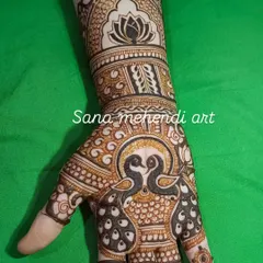 A stunning design centered around two kissing peacocks on the palm, with a lotus motif on the wrist. This is a very romantic and traditional design.