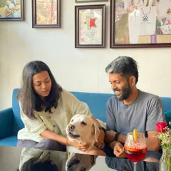 A moment of shared affection between a family and their gentle Labrador. It's these quiet, loving interactions that fill our café with warmth.