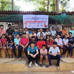A moment of rest with the team after a tough session. This group photo from our free kickboxing camp shows the diverse group of students who came together to learn, grow, and support one another.
