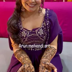 A happy bride showing off her personalized portrait mehendi. The joy on her face is my biggest reward.