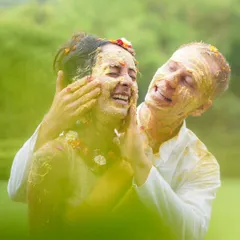 A playful moment between the couple during their Haldi. The genuine smiles and vibrant yellow hues make this an incredibly happy and heartwarming shot.