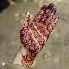 A beautiful example of a mature henna stain. The color is deep and rich, making the intricate floral and paisley patterns stand out.