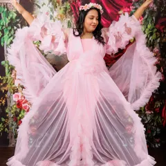Pure joy and freedom in a single frame. This mom-to-be is celebrating her journey in a whimsical pink ruffled gown, complete with a floral crown for an ethereal touch. My aim is to capture the powerful and joyful spirit of motherhood in every shot.