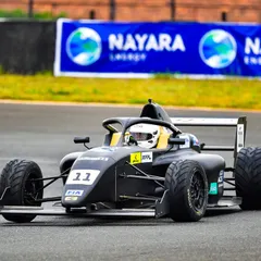 An F4 car speeds down the track at the Indian Racing Festival. We manage all track-side branding, ensuring high visibility for sponsors like Nayara Energy.