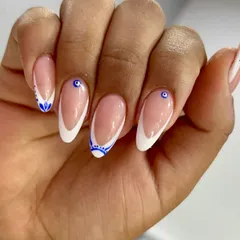Protected, polished, and powerful. I updated the classic French with intricate blue evil eye designs, adding a touch of symbolic art to a timeless style.